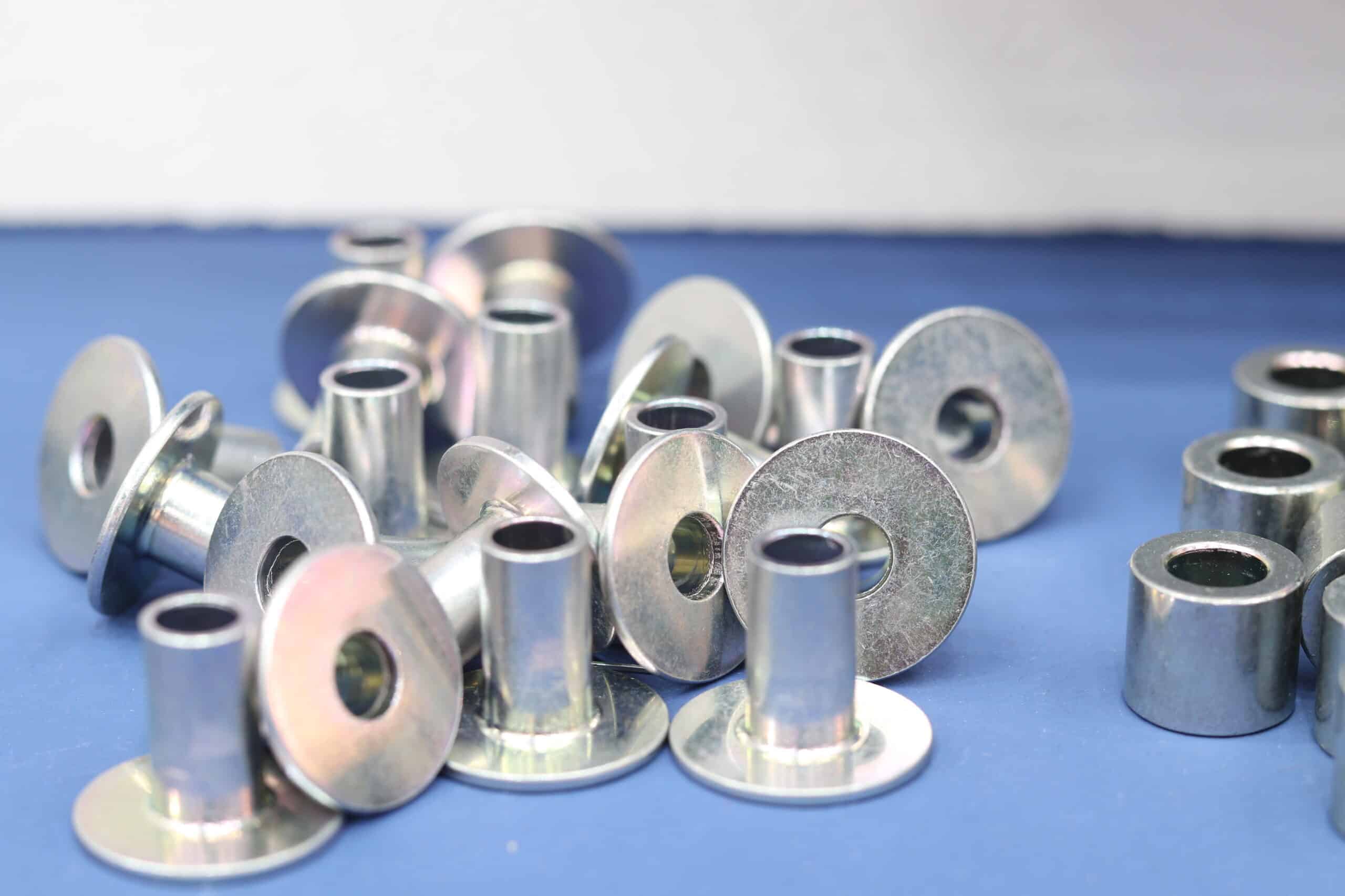  Steel parts with zinc plating added during manufacturing process on blue surface